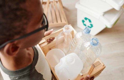 boy-recycling-plastic-bottles-at-home-2022-01-27-18-55-54-utc.jpg