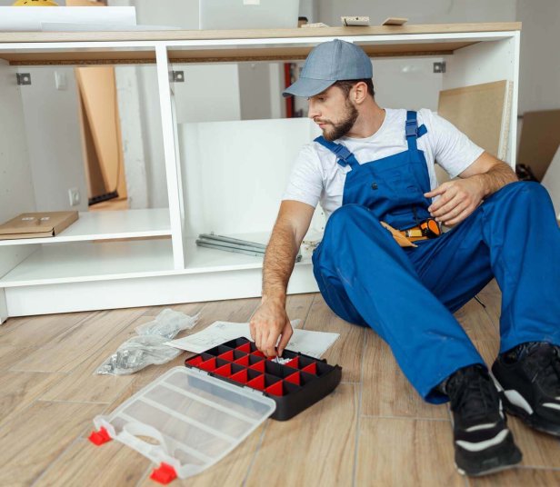 focused-handyman-in-overalls-sitting-on-the-floor-2022-09-06-03-44-29-utc.jpg