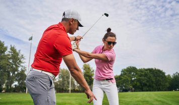 golfer-mastering-a-swing-technique-assisted-by-her-2023-11-27-05-27-42-utc.jpg