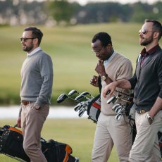 multiethnic-golfers-holding-bags-with-golf-clubs-a-2023-11-27-04-53-48-utc.jpg