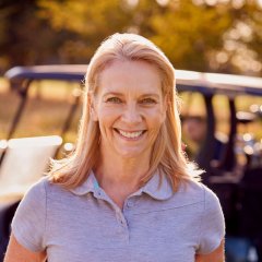 portrait-of-smiling-mature-female-golfer-standing-2023-11-27-04-55-42-utc.jpg