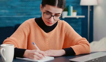 portrait-of-woman-smiling-and-writing-course-repor-2022-05-18-23-24-23-utc.jpg