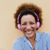 senior-african-woman-listening-music-with-headphon-2023-11-27-05-26-13-utc.jpg