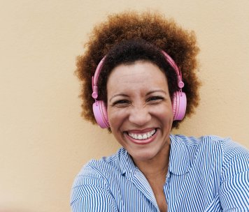 senior-african-woman-listening-music-with-headphon-2023-11-27-05-26-13-utc.jpg